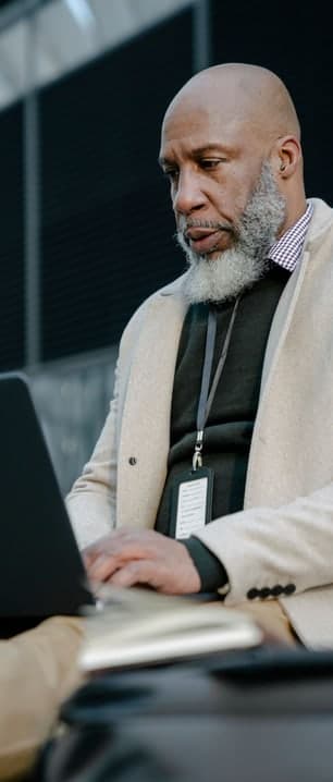 Black professional using a laptop; illustrative stock photograph