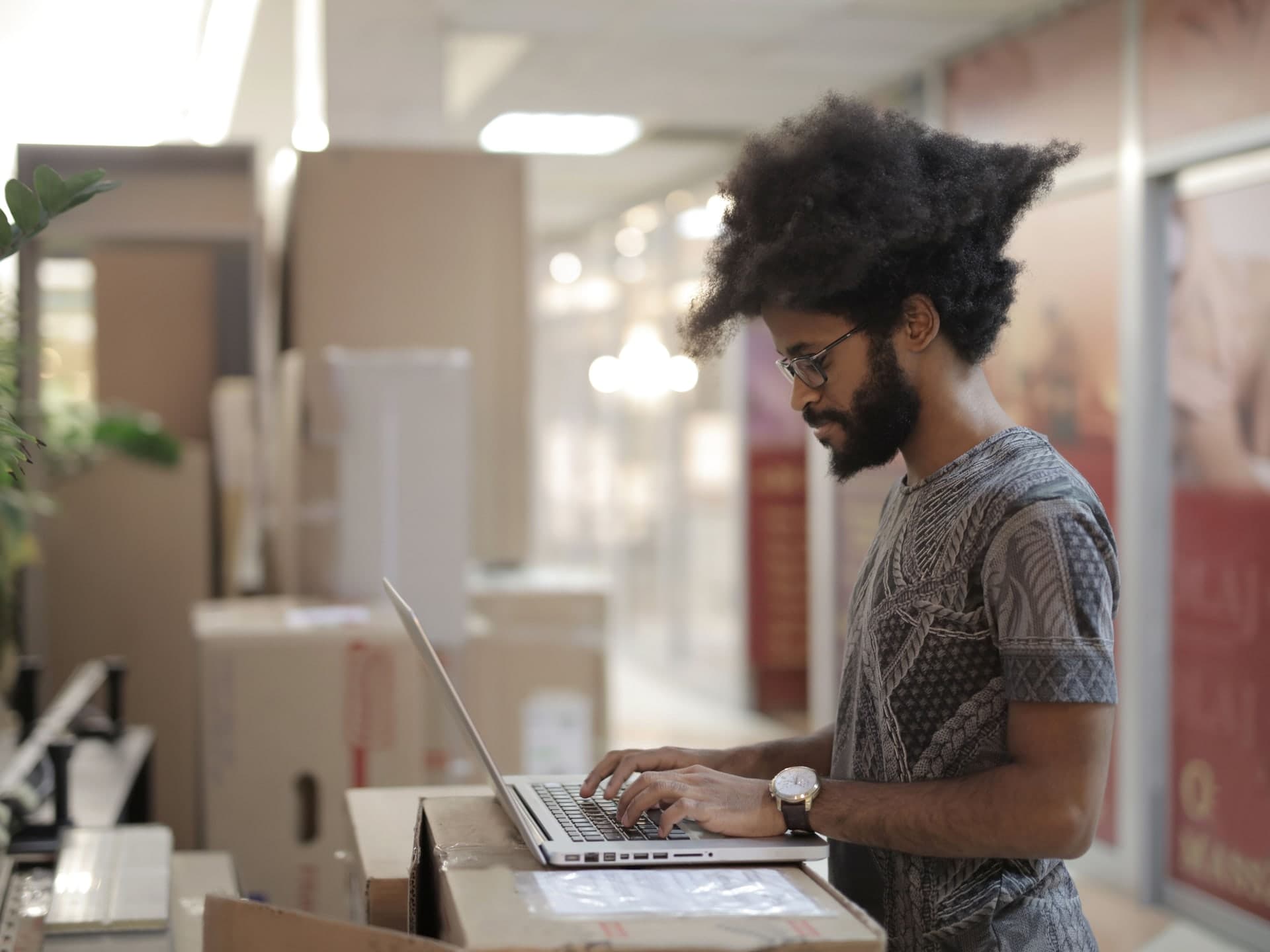 Black professional working on a laptop; stock photograph