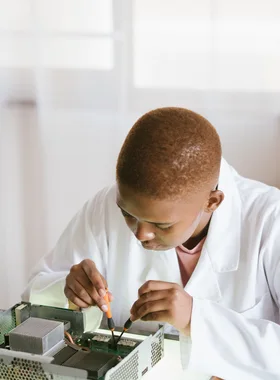 Black technician repairing computer hardware