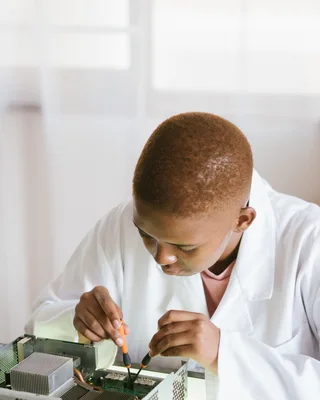 Black technician repairing computer hardware