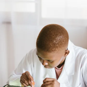 Black technician repairing computer hardware