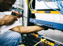 Black technician servicing hardware in a data centre