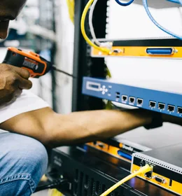 Black technician servicing hardware in a data centre