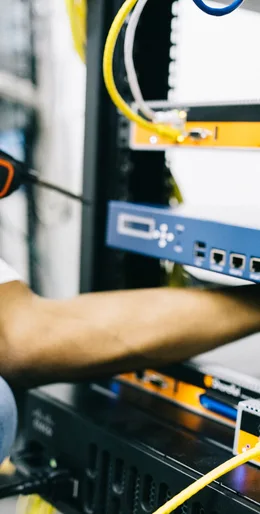 Black technician servicing hardware in a data centre