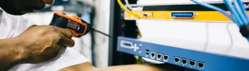 Black technician servicing hardware in a data centre