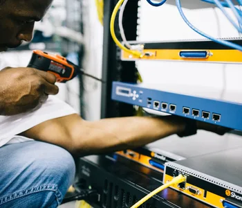 Black technician servicing hardware in a data centre