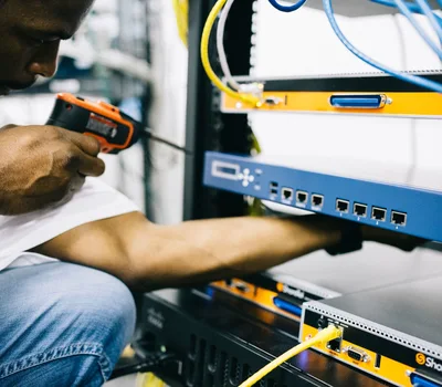 Black technician servicing hardware in a data centre