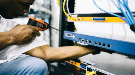 Black technician servicing hardware in a data centre