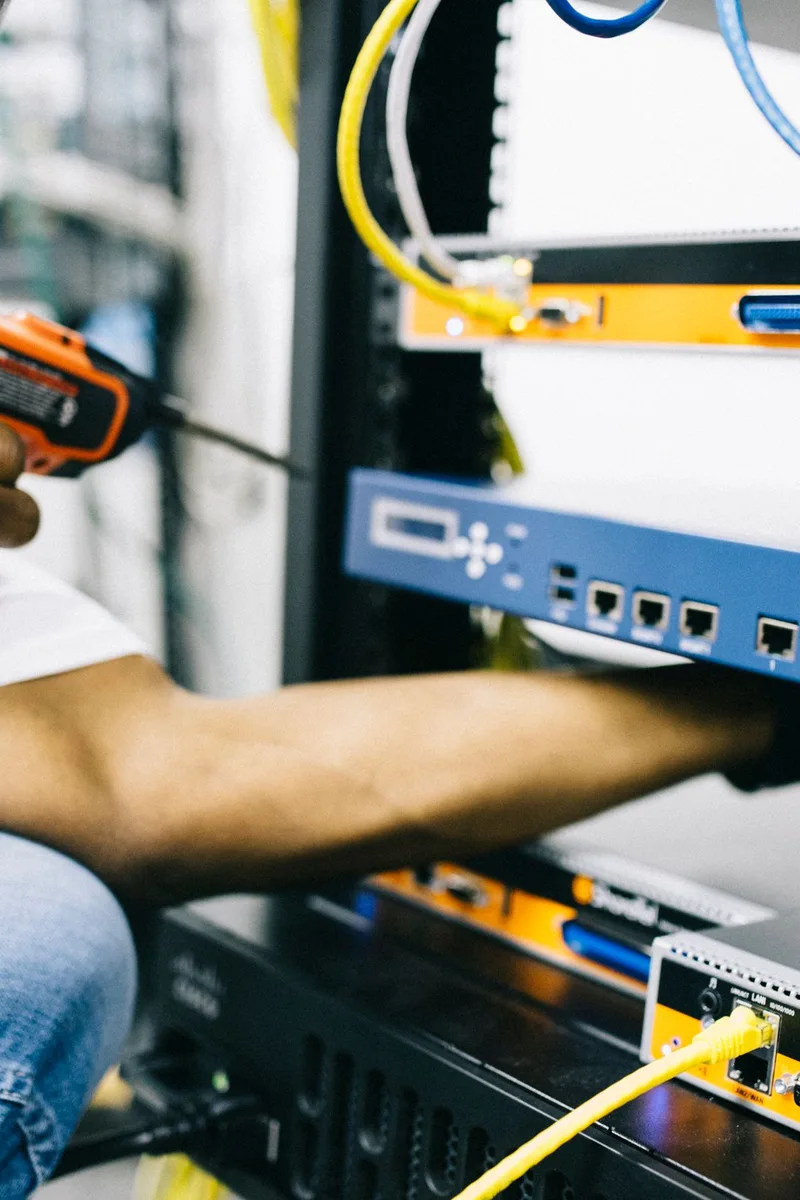 Black technician servicing hardware in a data centre