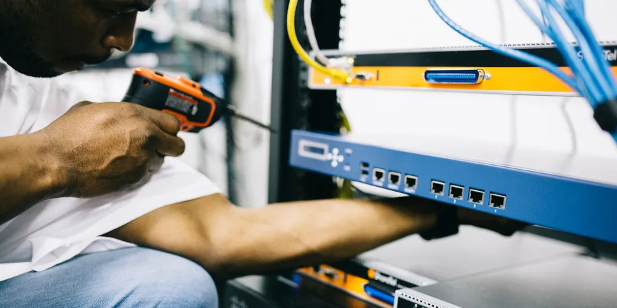 Black technician servicing hardware in a data centre