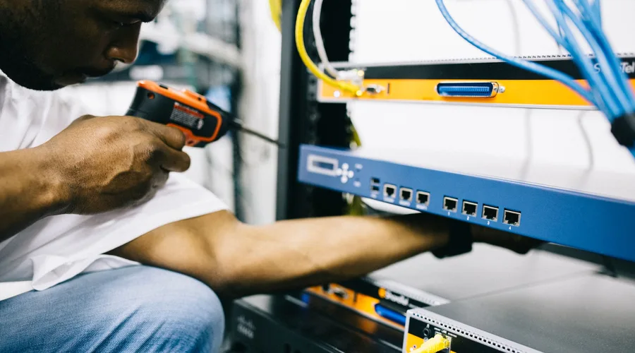 Black technician servicing hardware in a data centre