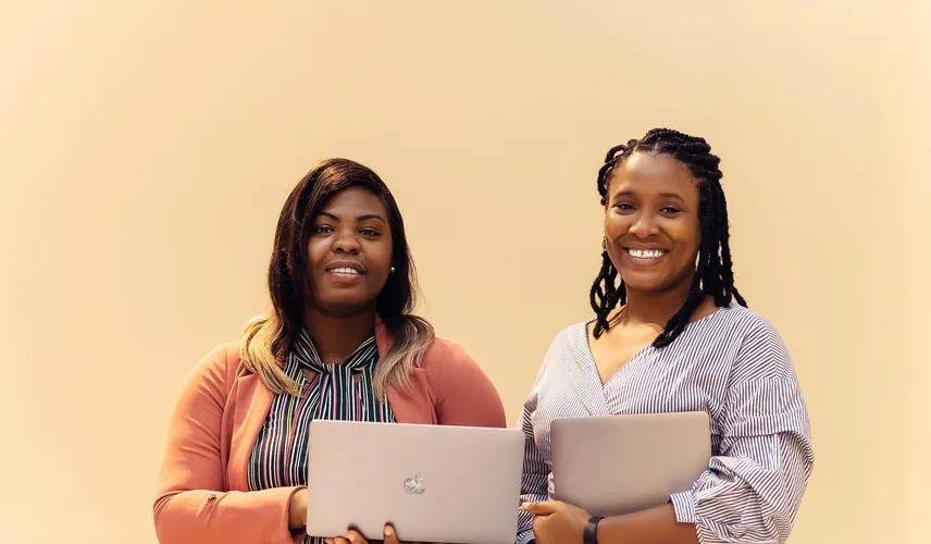African businesswomen collaborating with laptops
