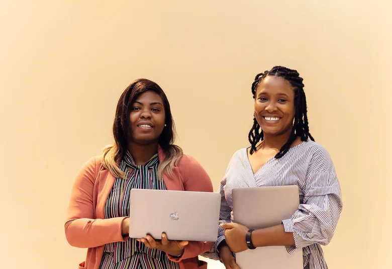 African businesswomen collaborating with laptops