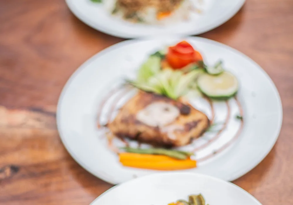 Three colourful plated dishes photographed in Uganda