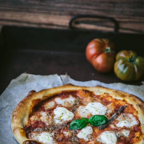 Freshly baked Margherita pizza with basil