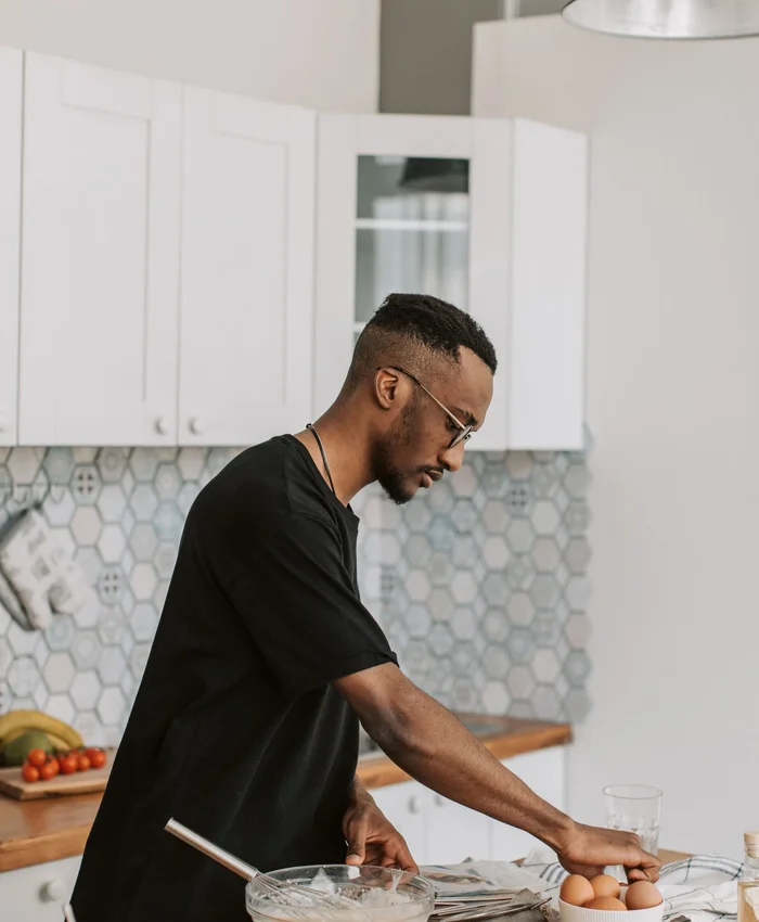 Black man preparing food in a kitchen