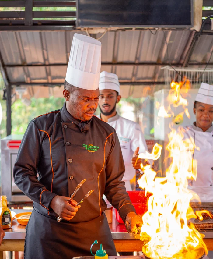 Chefs demonstrating cooking with fire in Uganda