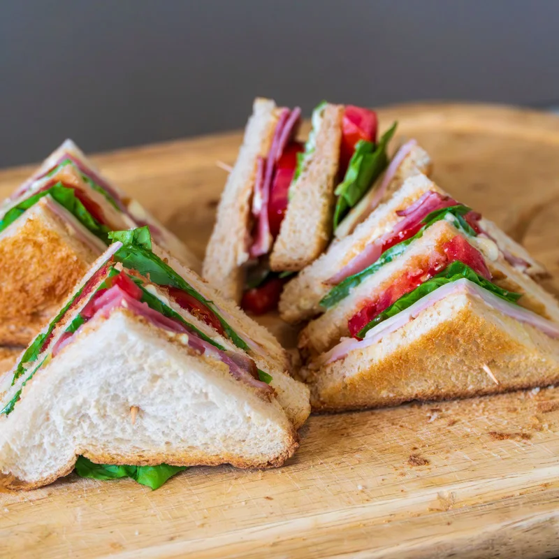 Club sandwich served on a wooden board