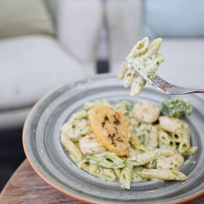 Creamy penne pasta with vegetables and shrimp
