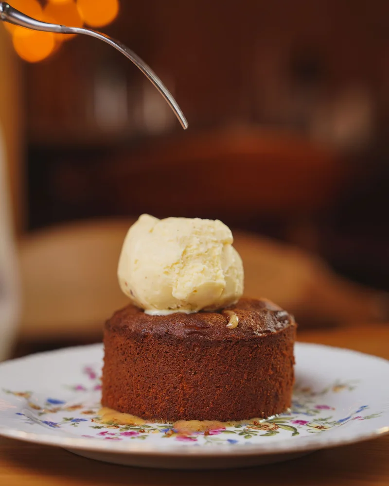 Cake served with a scoop of ice cream