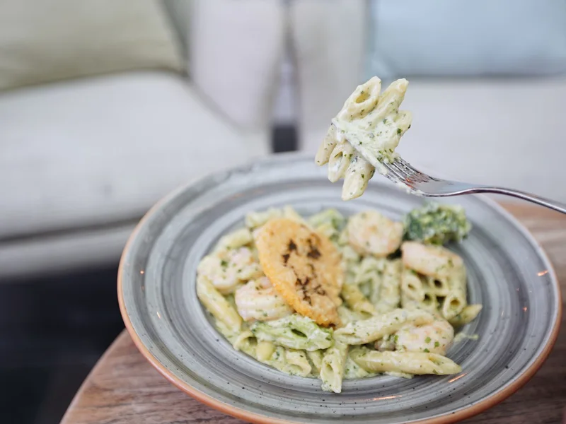 Creamy penne pasta with vegetables and shrimp