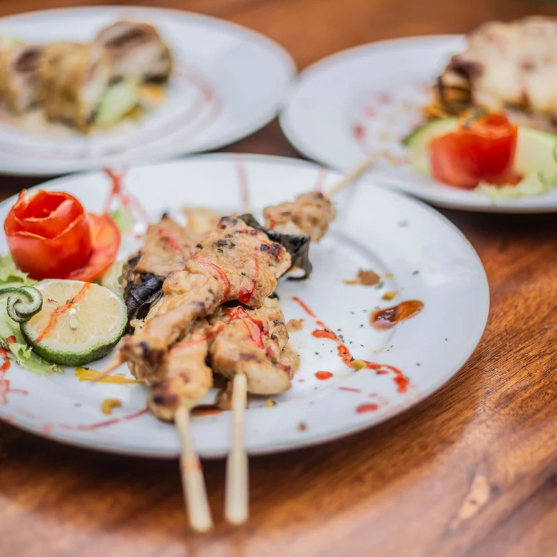 Chicken skewers and plated cuisine in Uganda