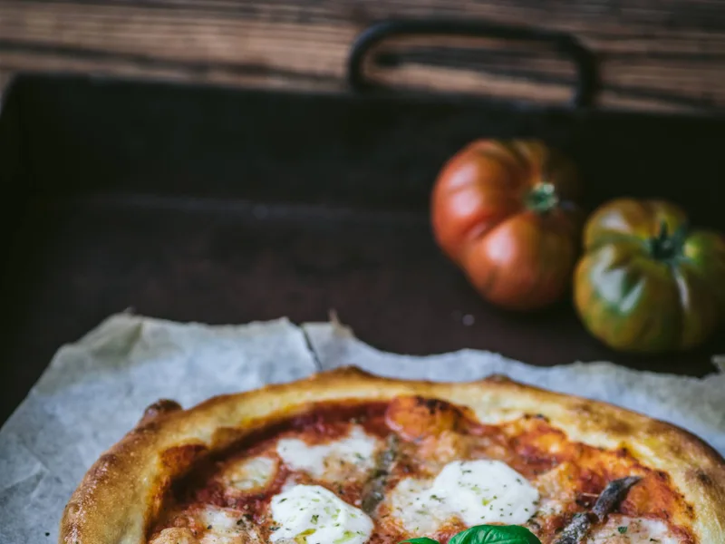 Freshly baked Margherita pizza with basil
