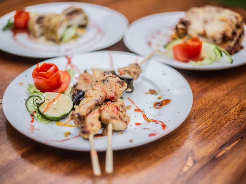 Chicken skewers and plated cuisine in Uganda