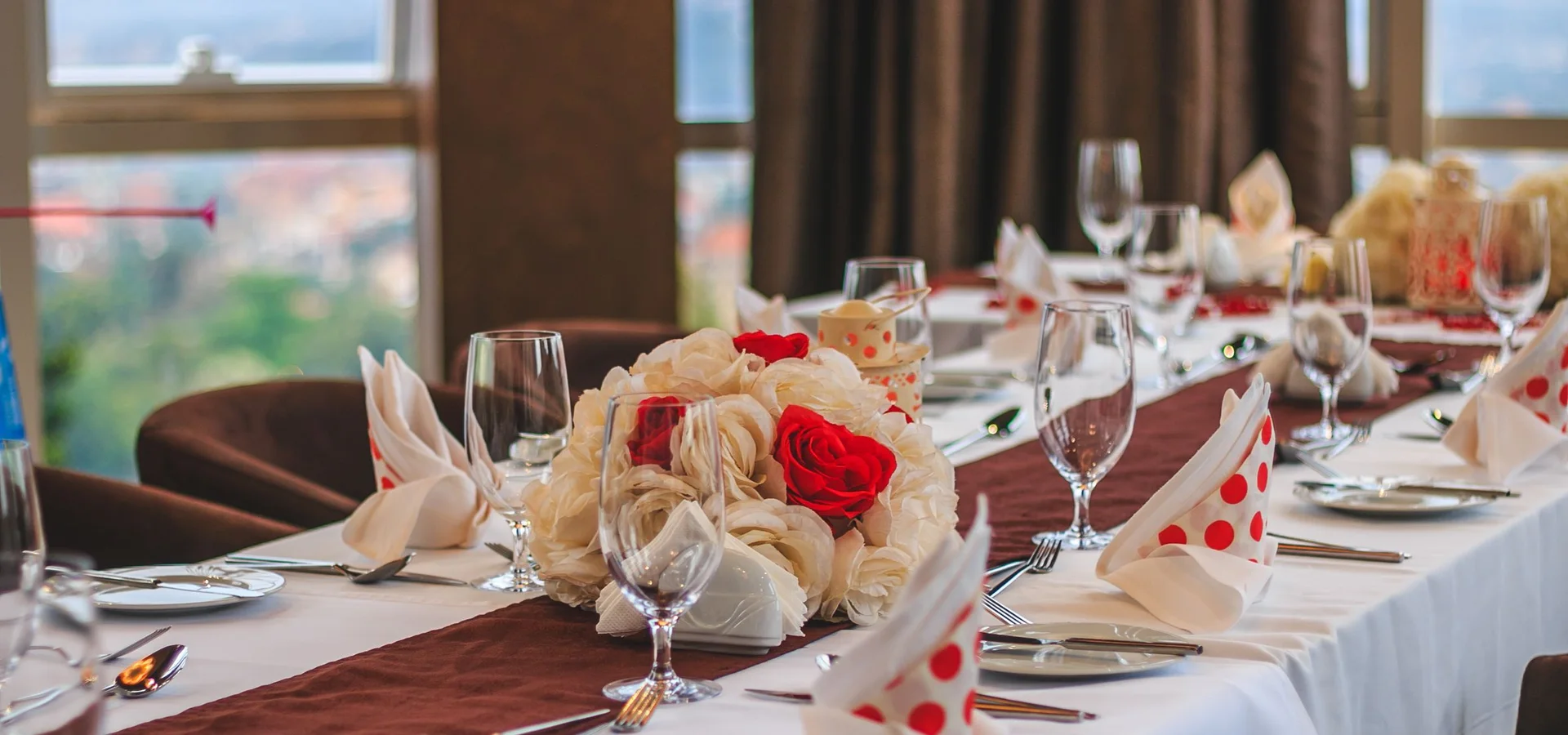 Dining tables set beside windows in Kampala