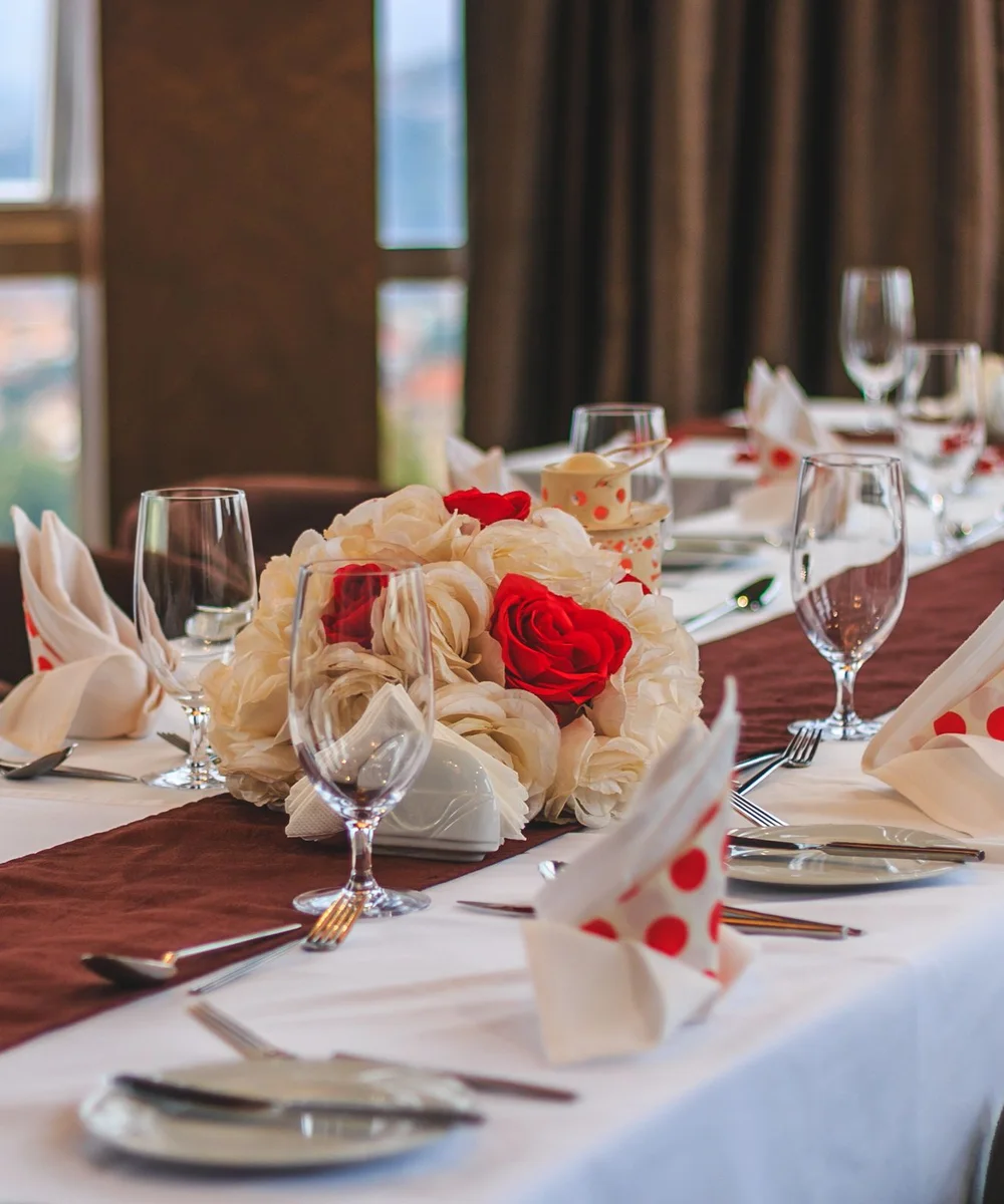 Dining tables set beside windows in Kampala