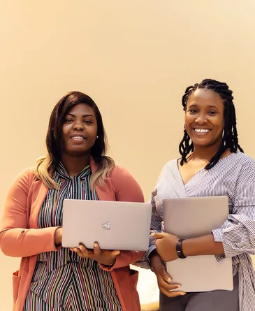 African businesswomen collaborating with laptops