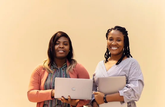 African businesswomen collaborating with laptops