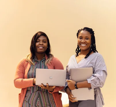 African businesswomen collaborating with laptops