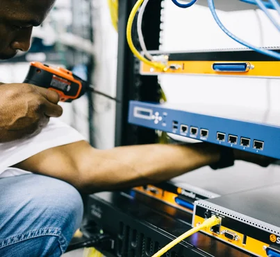 Black technician servicing hardware in a data centre