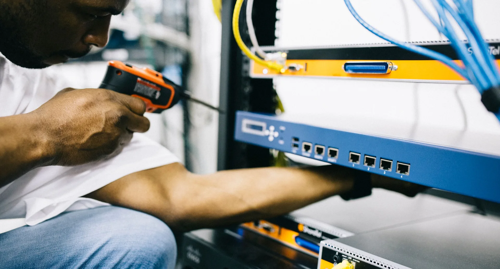 Black technician servicing hardware in a data centre