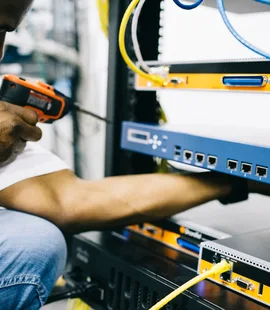 Black technician servicing hardware in a data centre