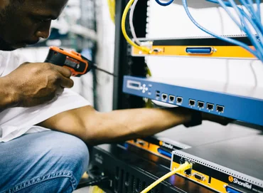 Black technician servicing hardware in a data centre