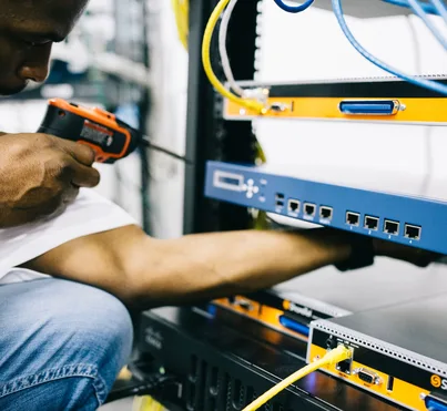 Black technician servicing hardware in a data centre