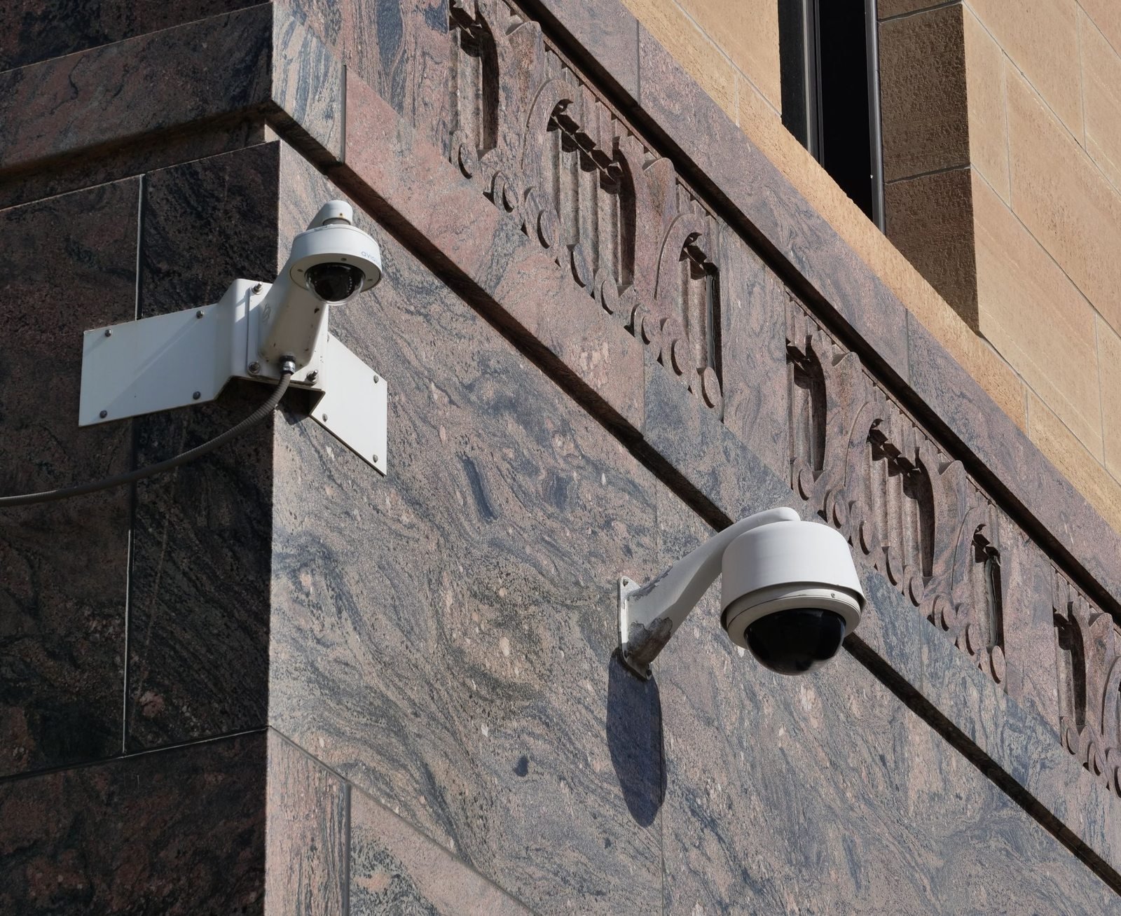 Modern surveillance cameras mounted on a building