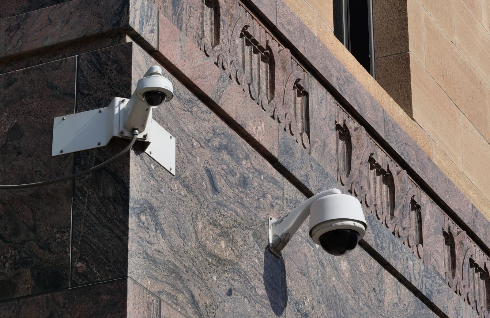 Modern surveillance cameras mounted on a building
