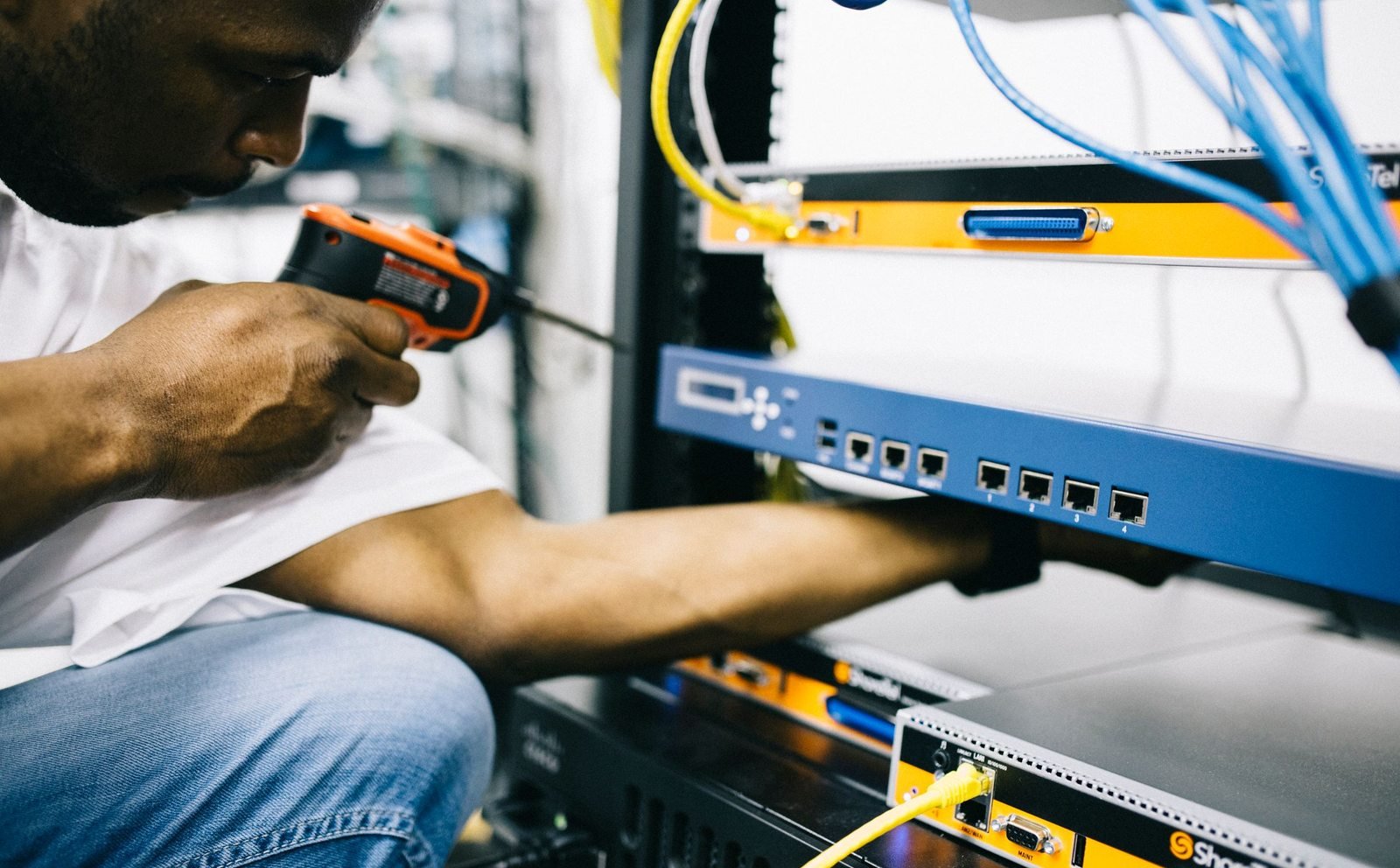 Black technician servicing hardware in a data centre