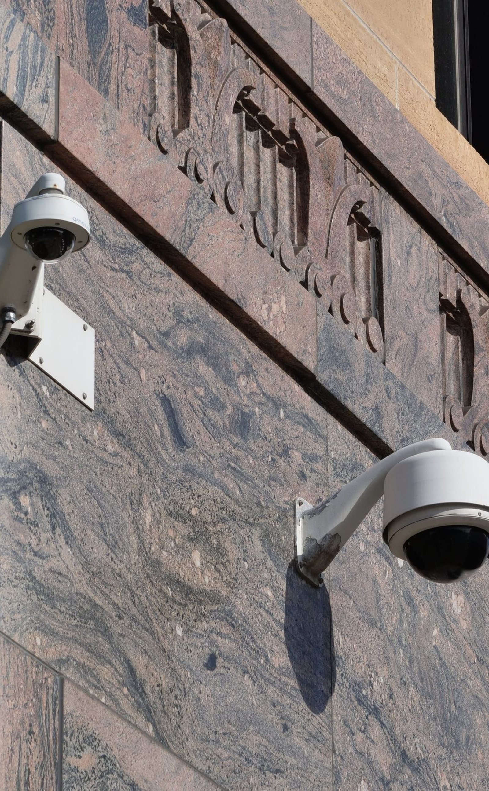 Modern surveillance cameras mounted on a building