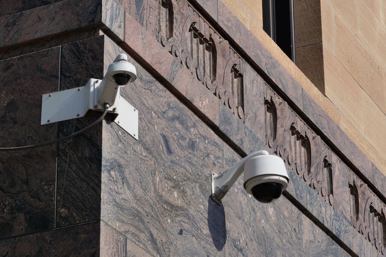 Modern surveillance cameras mounted on a building