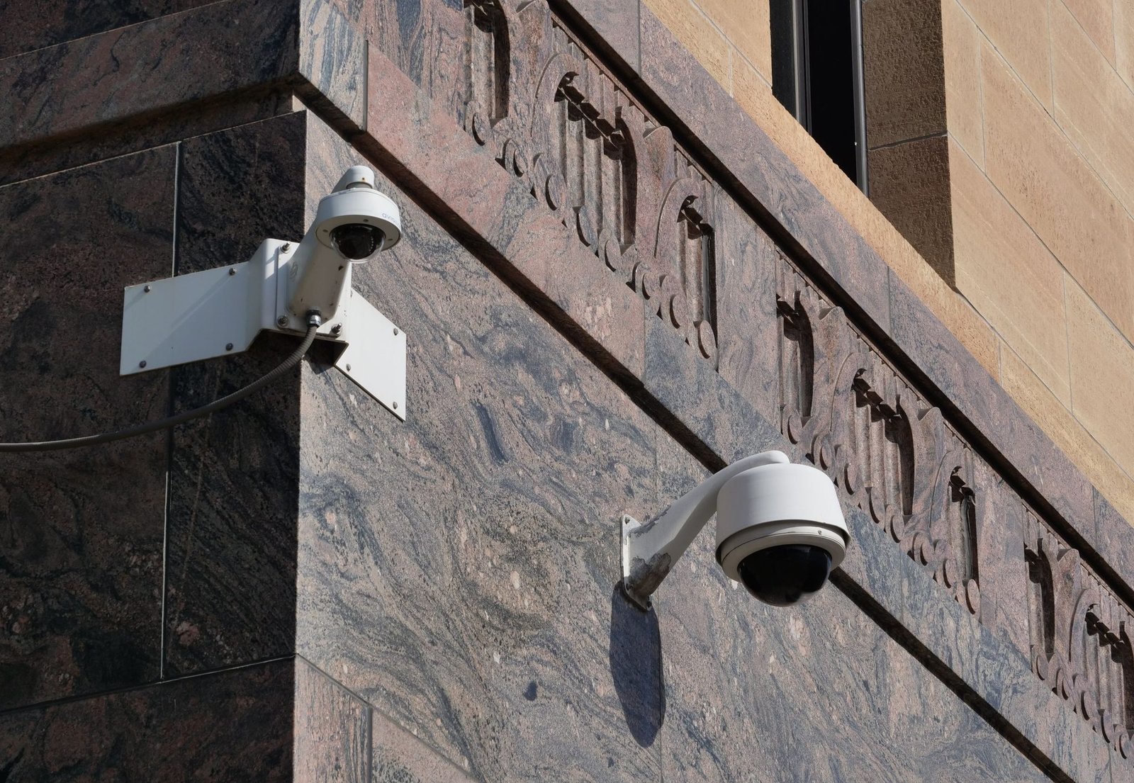 Modern surveillance cameras mounted on a building