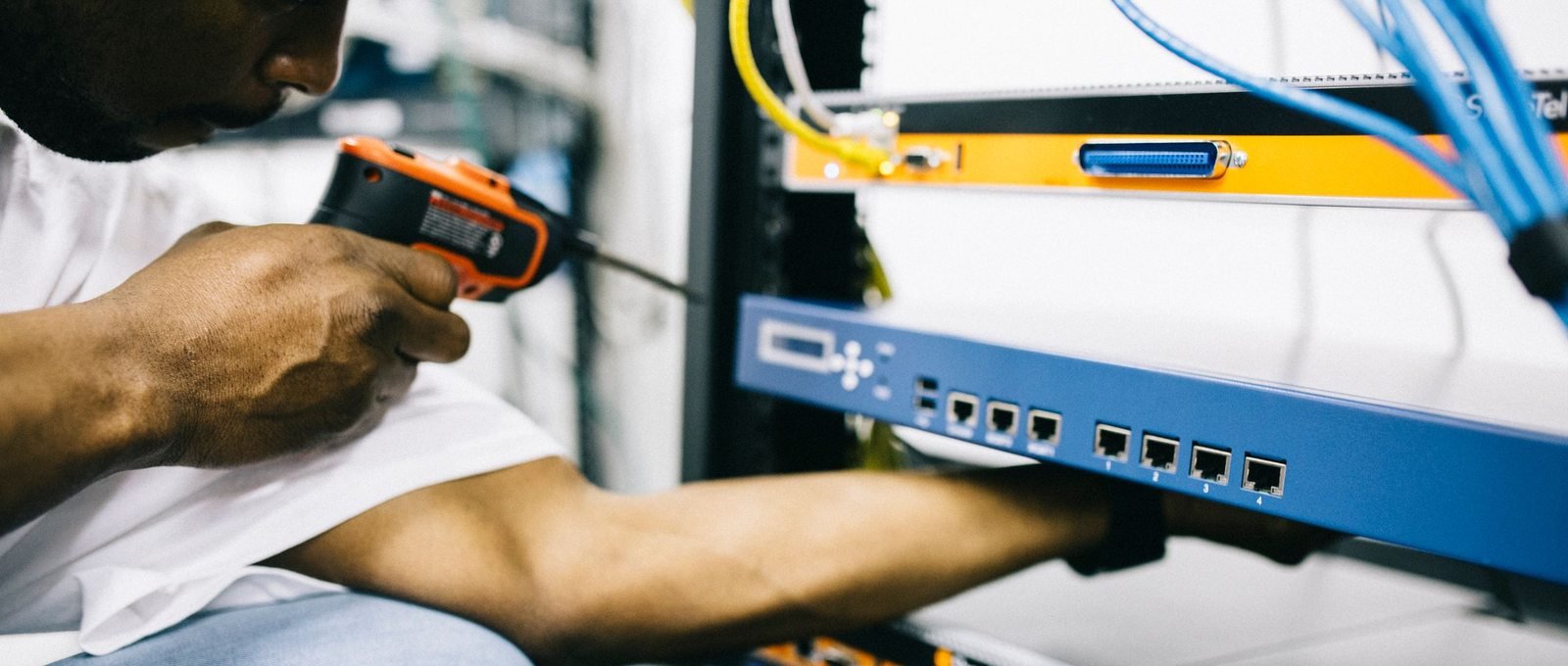 Black technician servicing hardware in a data centre