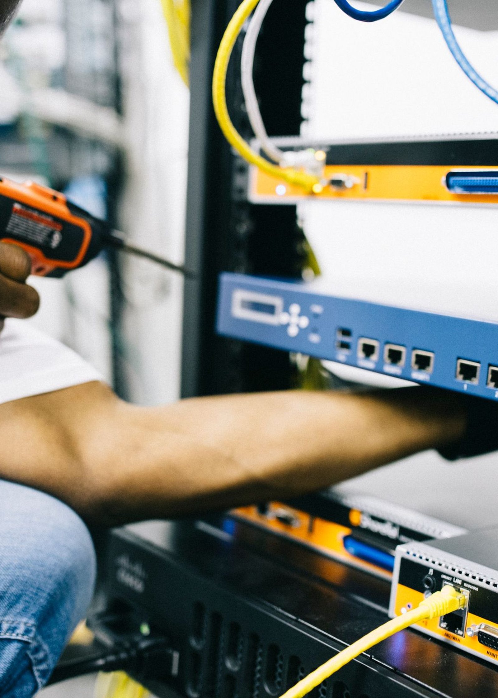 Black technician servicing hardware in a data centre