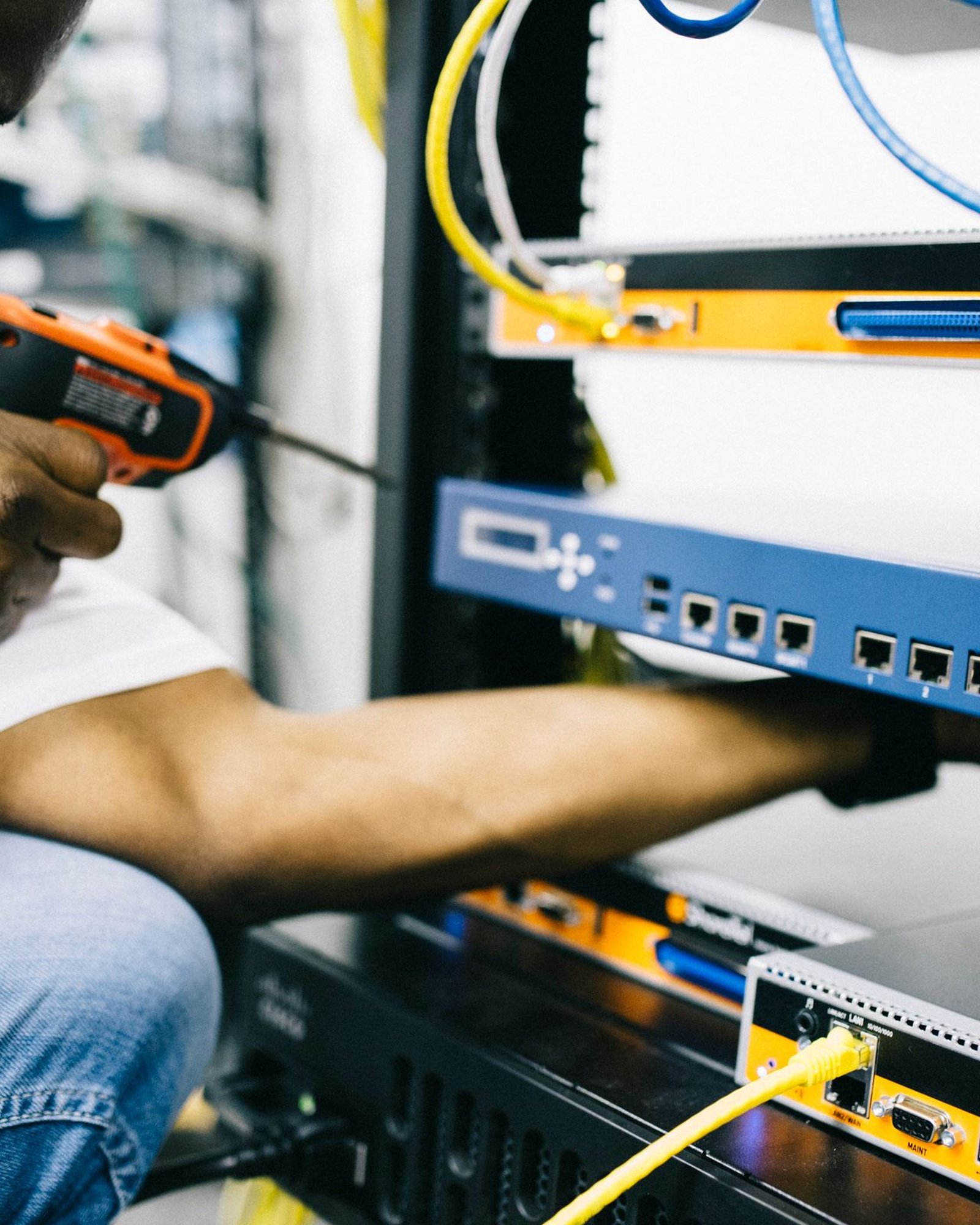 Black technician servicing hardware in a data centre