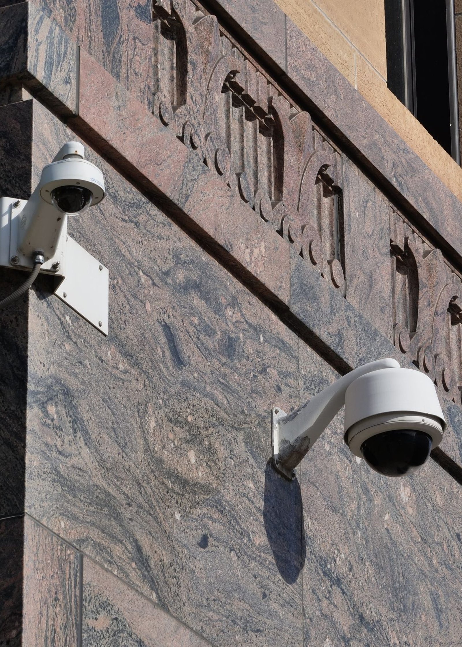 Modern surveillance cameras mounted on a building