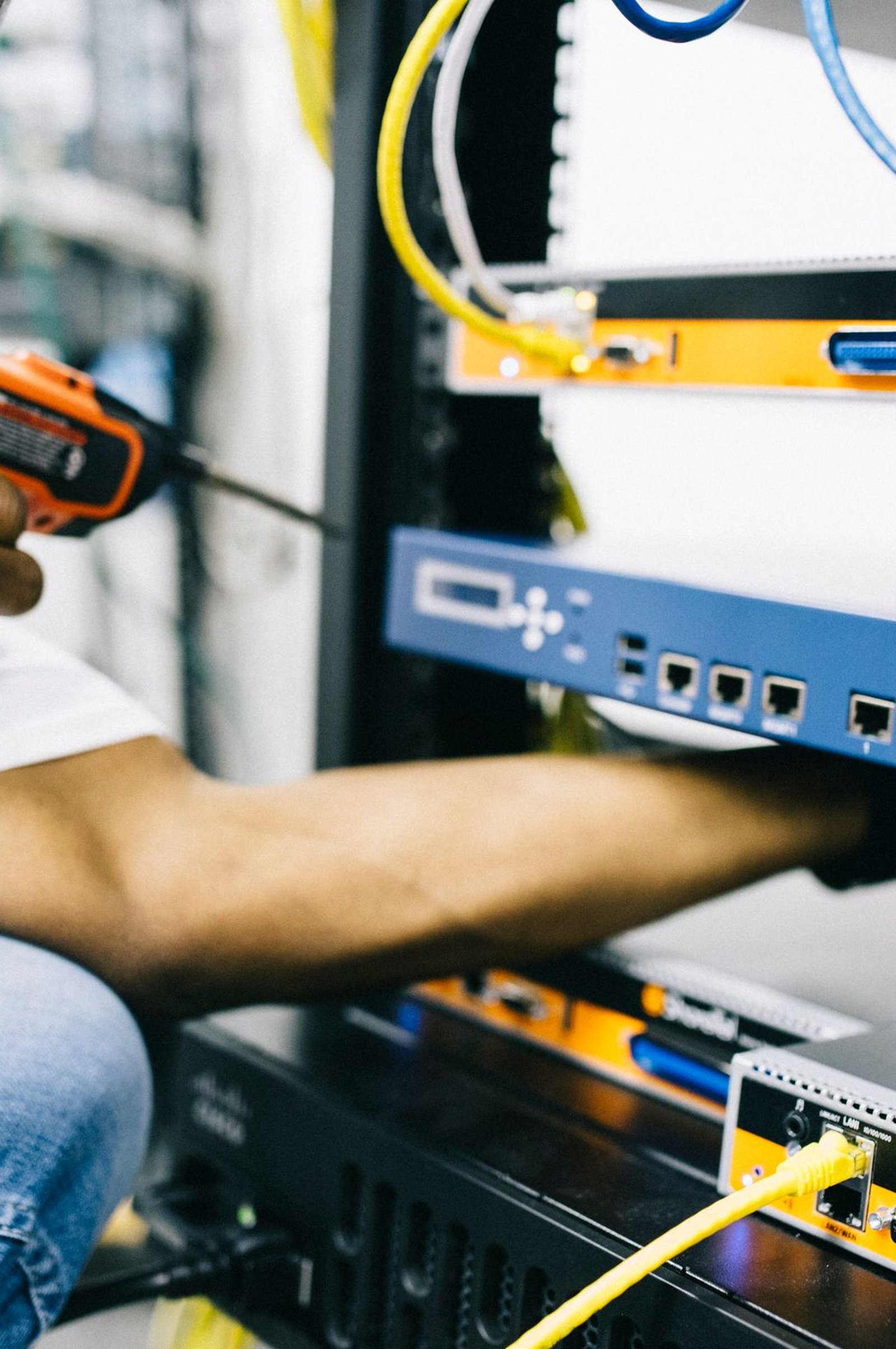 Black technician servicing hardware in a data centre