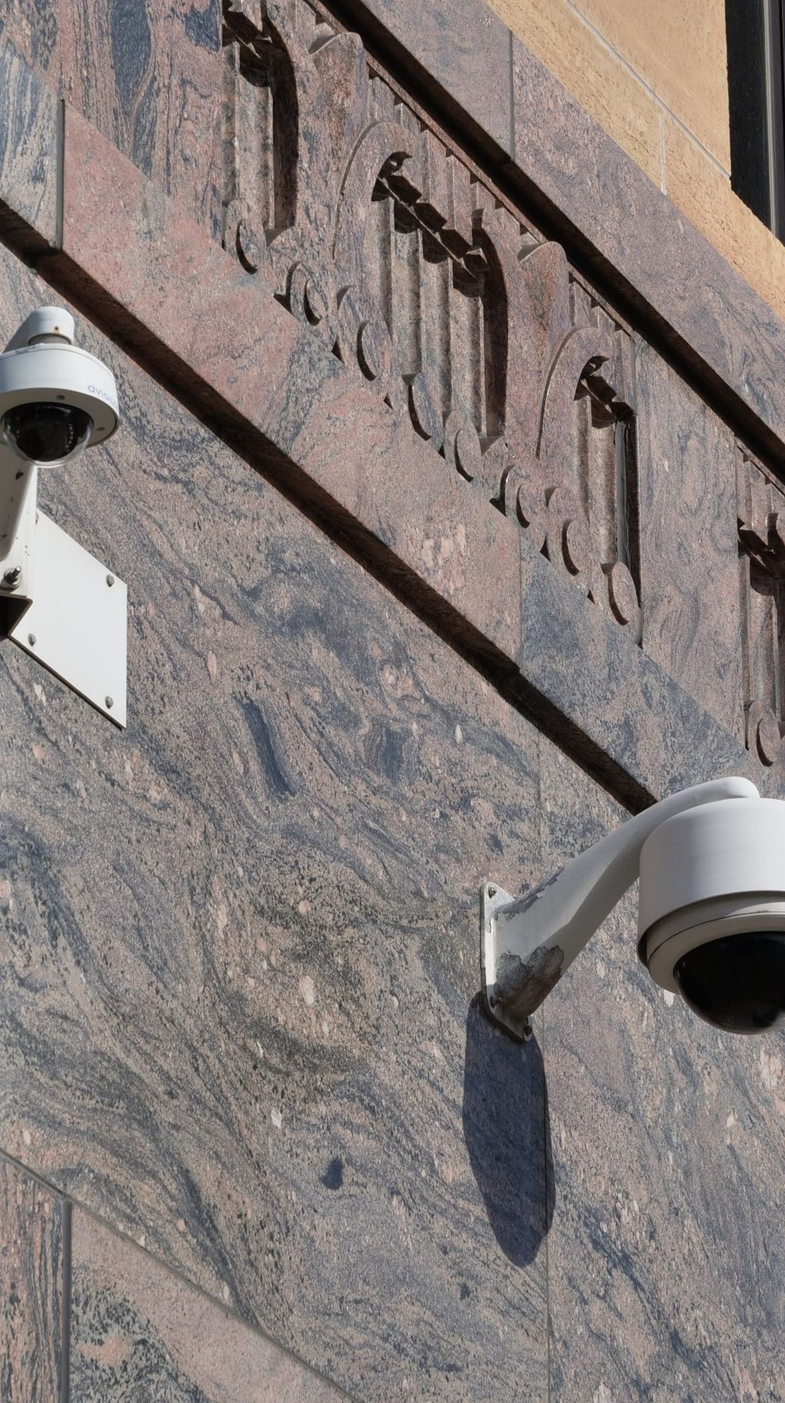 Modern surveillance cameras mounted on a building